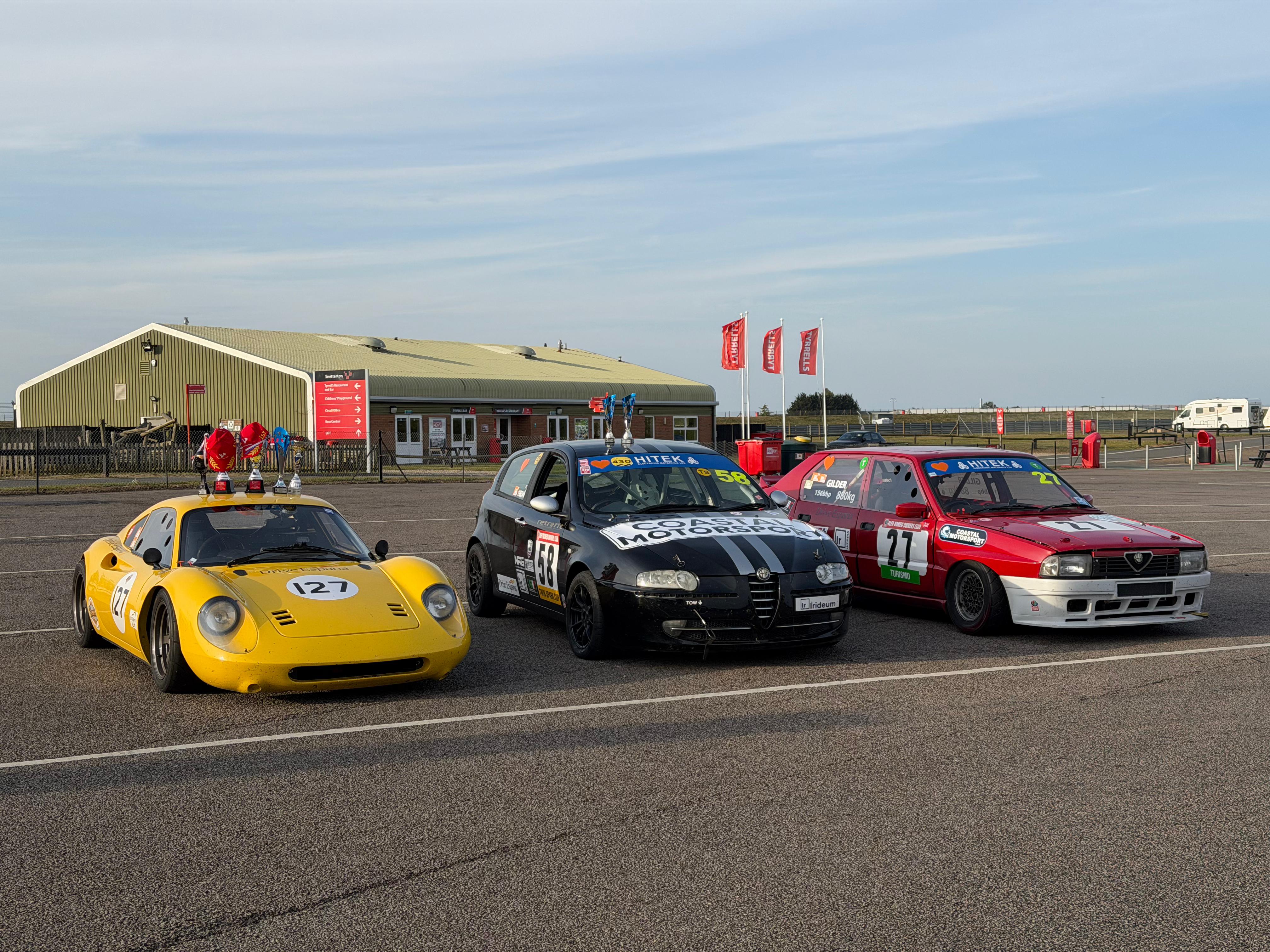 Coastal Motorsport Alfa Romeo race cars in the paddock
